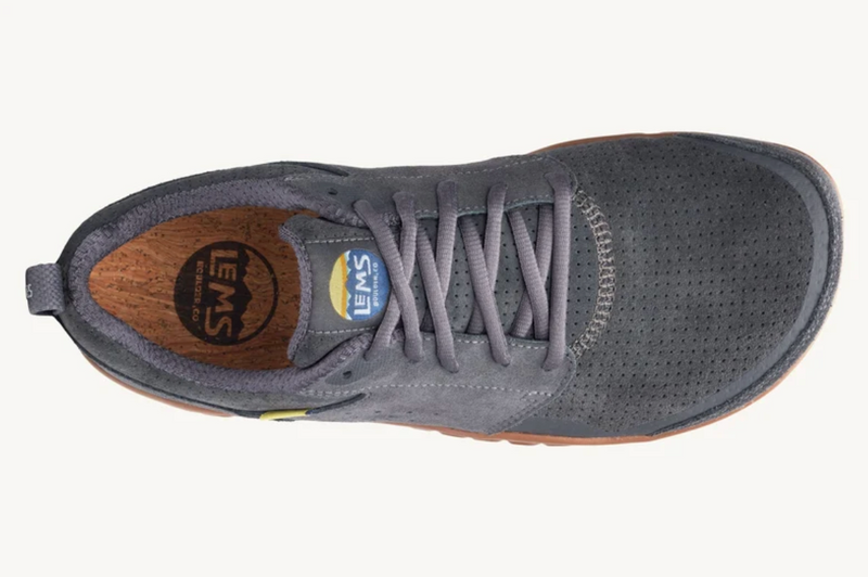 Load image into Gallery viewer, A top-down view of a dark gray Lems shoe with a brown cork-textured insole and gray laces, shown on a light off-white background.