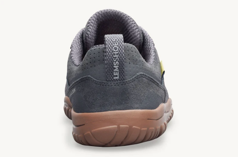 Load image into Gallery viewer, A rear view of a dark gray Lems shoe with a brown sole, shown against a plain off-white background.
