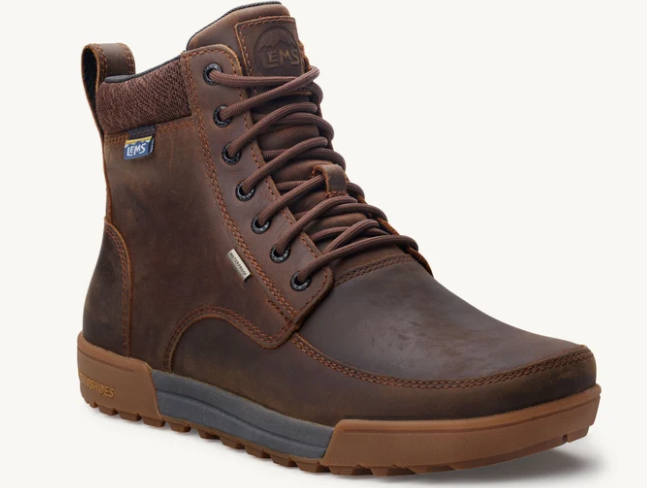 Load image into Gallery viewer, A brown leather high-top work boot with a pull tab, lace-up front, and a gray and brown sole, shown on a light off-white background.
