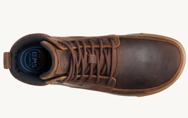 Load image into Gallery viewer, A top-down view of a brown leather lace-up boot with a dark brown toe cap and a blue circular insole visible inside the collar, set against a plain off-white background.
