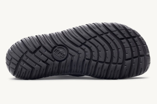 Close-up of a black shoe sole with tread pattern with a 'Lems' imprint