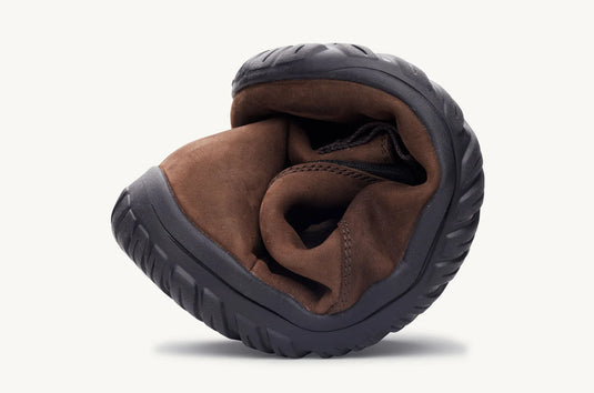 Brown Chelsea boot scrunched up to demonstrate flexibility of the sole.