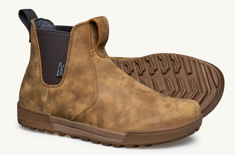 Load image into Gallery viewer, A pair of brown suede Chelsea-style boots with a dark elastic side panel and a thick brown lug sole, shown on a clean off-white background.
